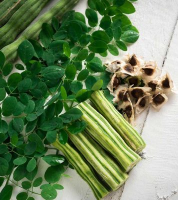 image of moringa oleifera leaves, seeds, and pods